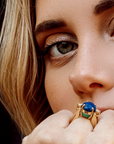 dynamic-gold-ring-natural-stones-in-hand.png