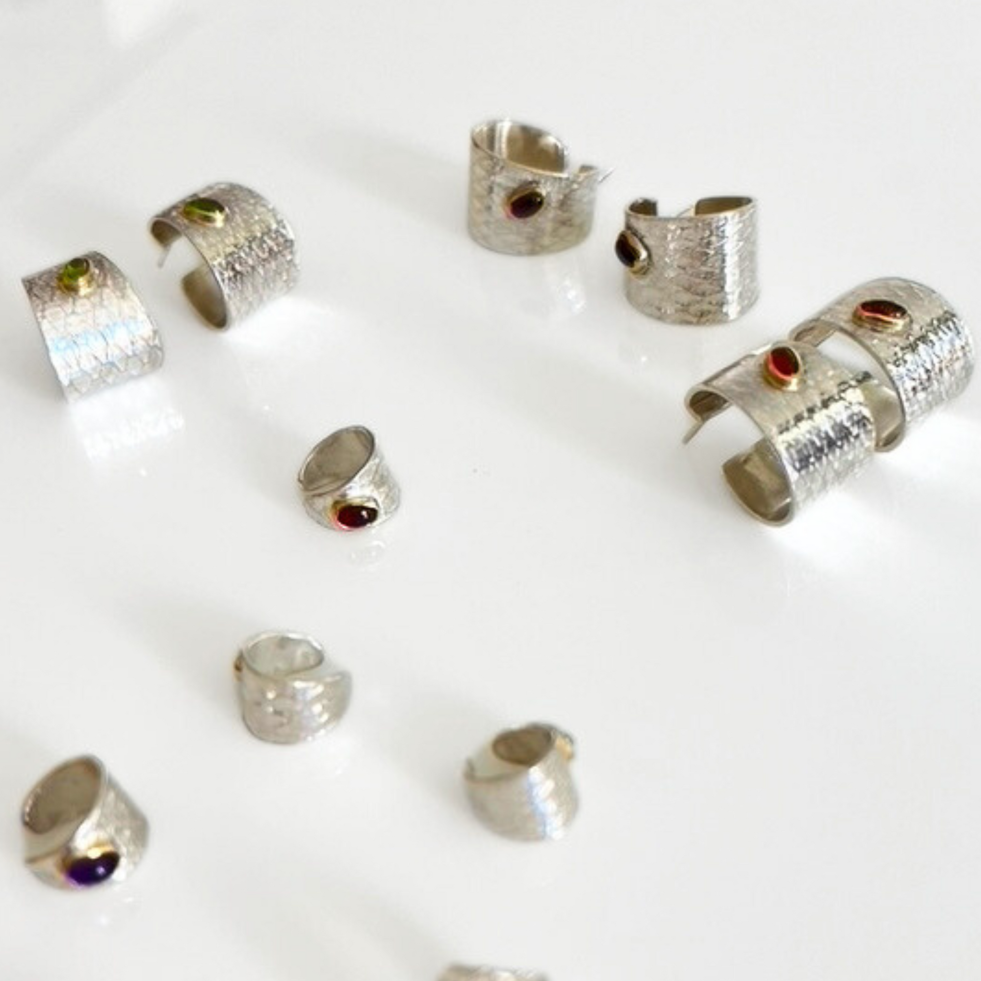 Reptilia silver earring with blue natural stone, close front view.