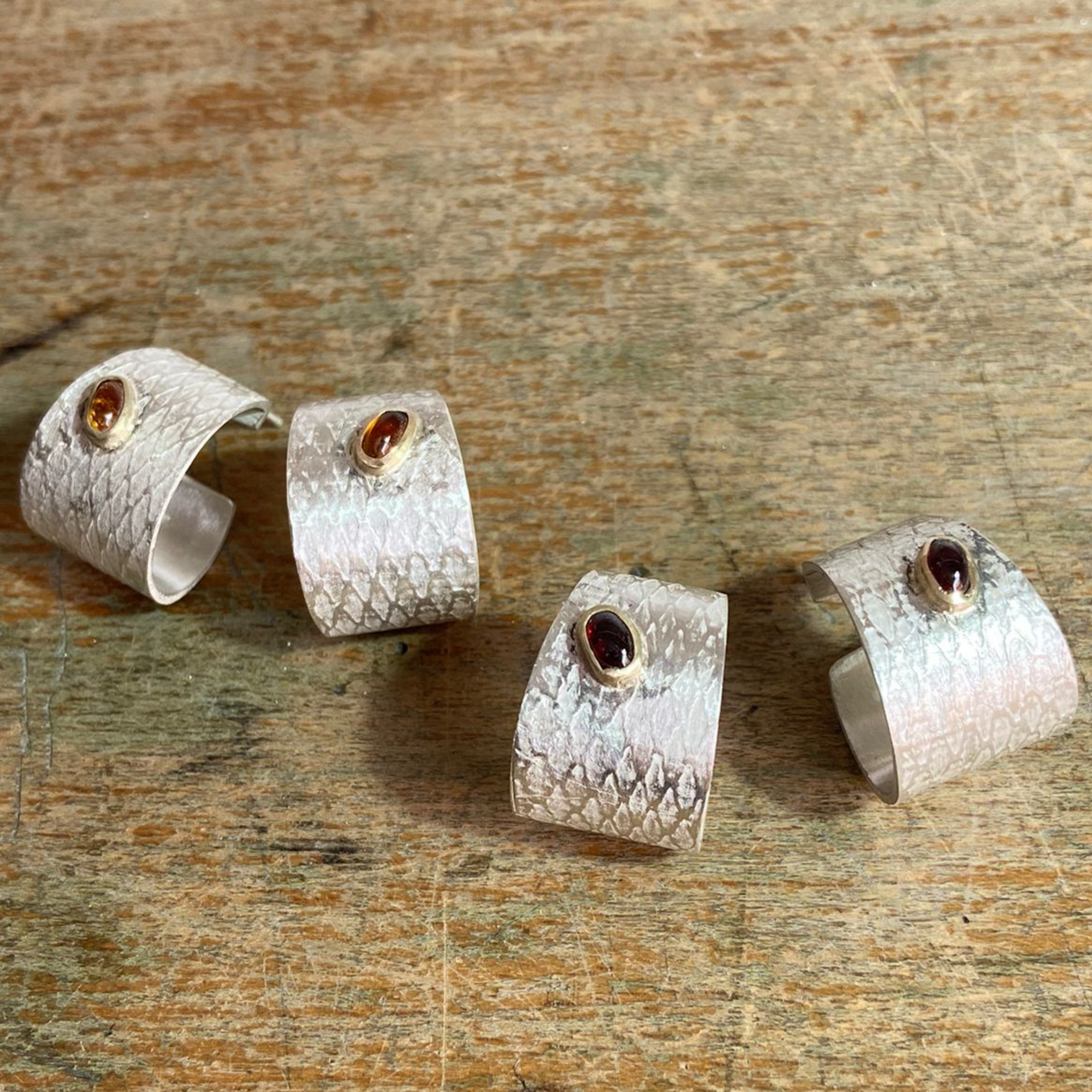 Reptilia silver earring with blue natural stone, side view of the cuff-like shape.