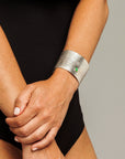 Reptilia Maxima silver cuff with green  cabochon, worn on wrist.